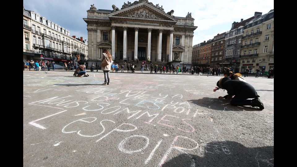 Davanti alla Borsa a Bruxelles scrivono col gesso messaggi pace