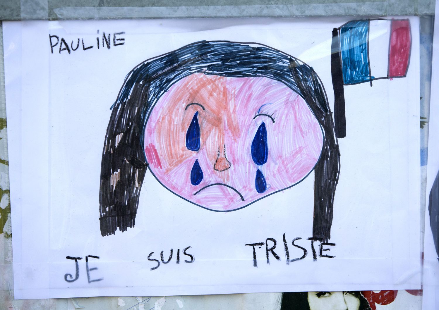 Il disegno di una bambina dopo gli attentati di Parigi pianto (afp)&nbsp;