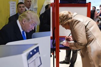 Donald Trump e Hillary Clinton durante il voto (foto Afp)