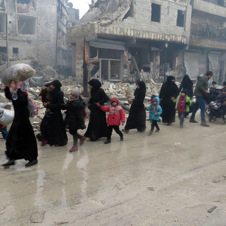 Civili in fuga mentre infuria la battaglia ad Aleppo Est (foto Afp)