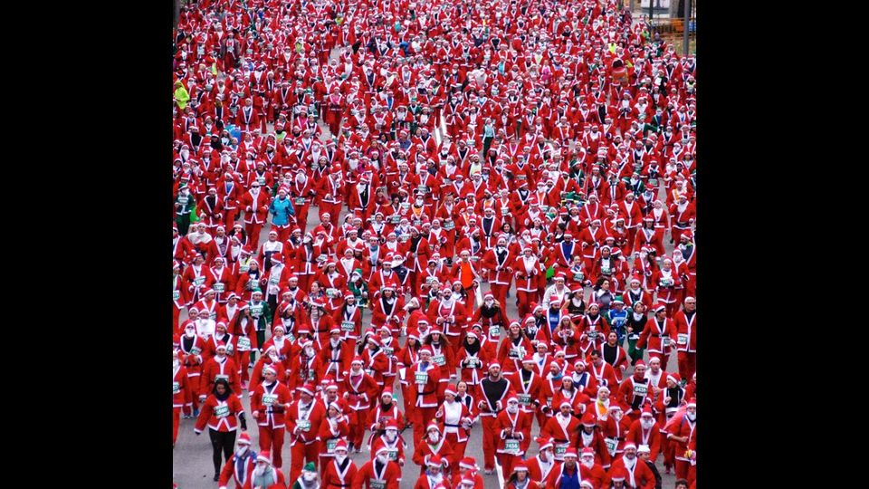 Spagna: centinaia di persone vestite da Babbo Natale partecipano alla 8 km di corsa per le strade di Madrid (foto Afp)&nbsp;
