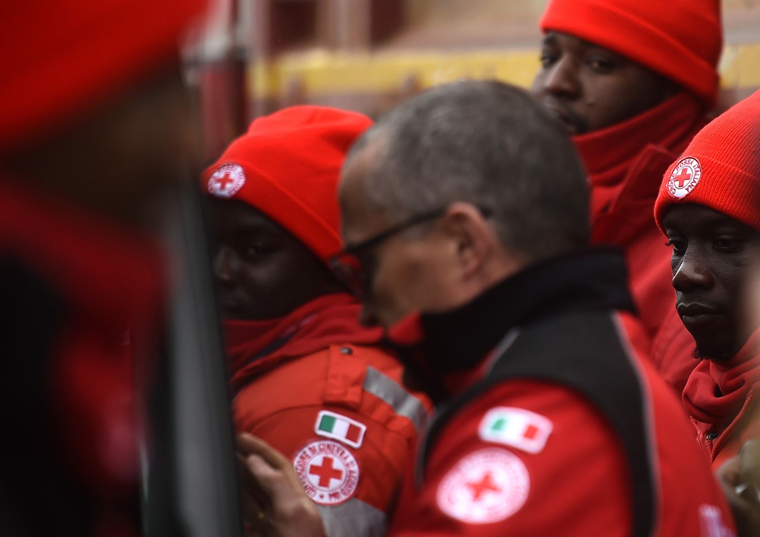 Un gruppo di migranti lavora insieme alla Croce Rossa al centro di coordinamento di operazioni a Penna (Afp) &nbsp;