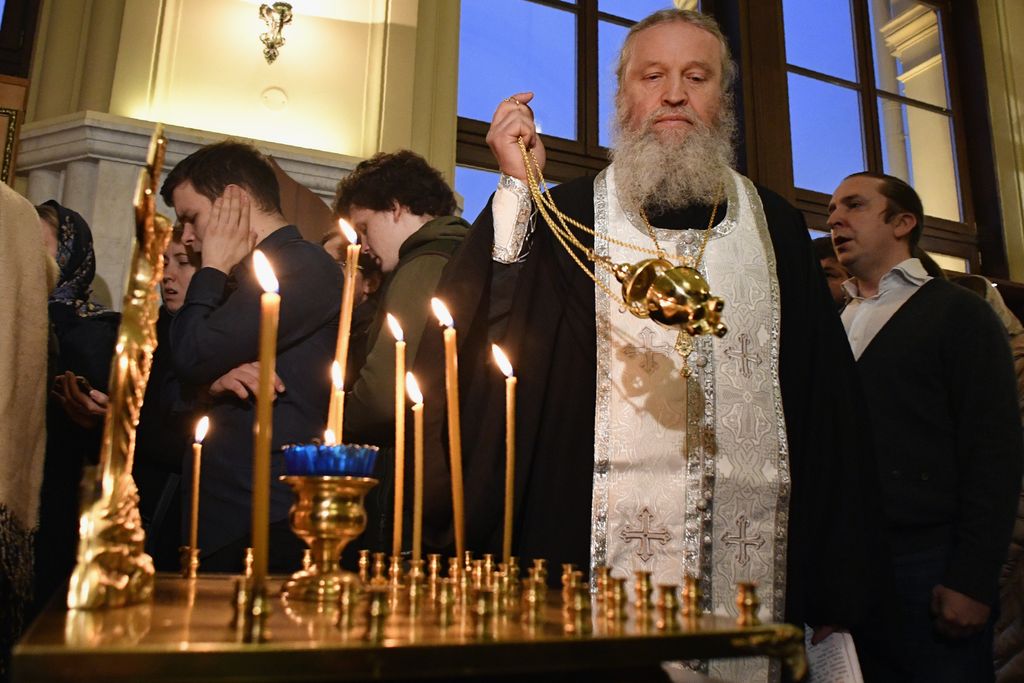 Un prete ortodosso celebra una preghiera in memoria delle vittime dell'esplosione nella metropolitana di San Pietroburgo in una cappella alla stazione ferroviaria di Leningradsky a Mosca (foto Afp)&nbsp;