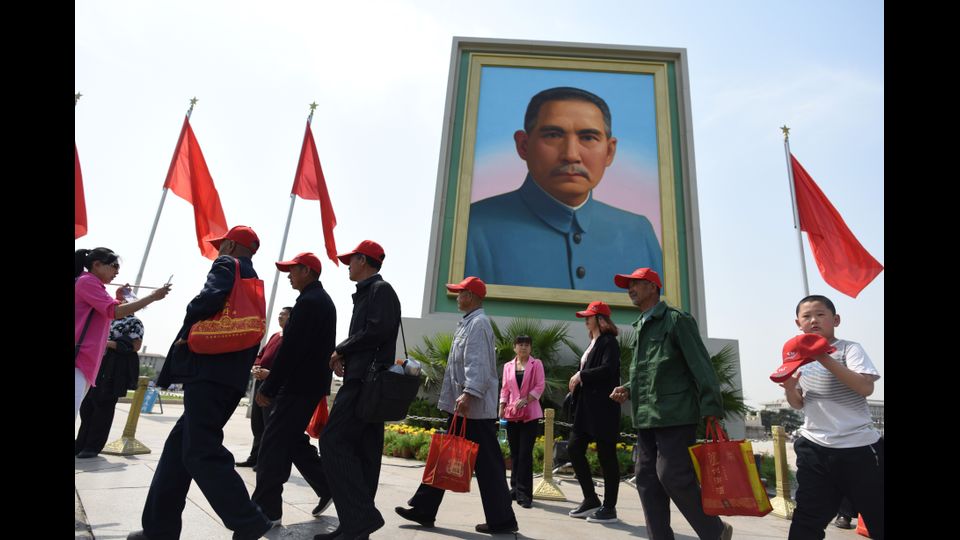 Cina - Visitatori camminano sotto un ritratto del leader nazionalista Sun Yat-sen in piazza Tiananmen durante la festa del 1 maggio a Pechino (Afp)&nbsp;