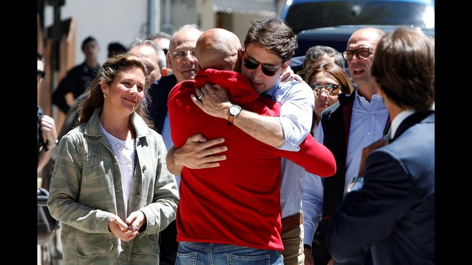 &nbsp;Justin Trudeau abbraccia il sindaco di Amatrice, Sergio Pirozzi (Afp)