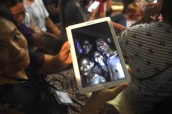 &nbsp;Un familiare mostra le immagini dei ragazzi trovati vivi nella grotta in Thailandia