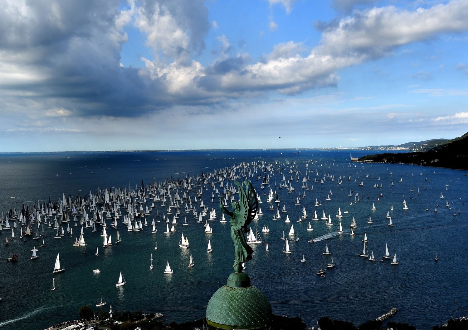 Le barche navigano oltre il &quot;Faro della Vittoria&quot; durante la 49esima regata di Barcolana nel Golfo di Trieste l'8 ottobre 2017. - Con circa 2072 navi, la Barcolana ha il maggior numero di partecipazioni di ogni regata velica al mondo. &nbsp;