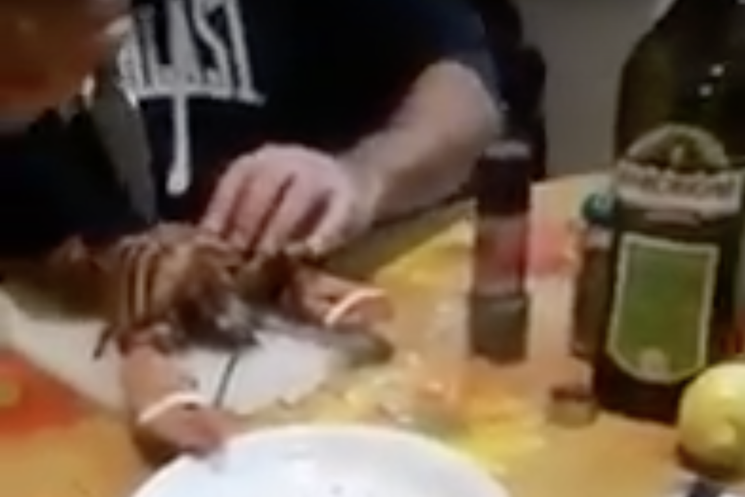 Un fotogramma del video in cui un uomo scanna un'aragosta viva