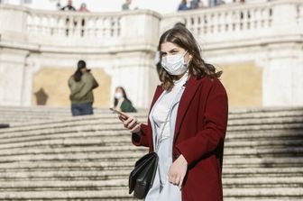 Turista con mascherina protettiva a Piazza di Spagna