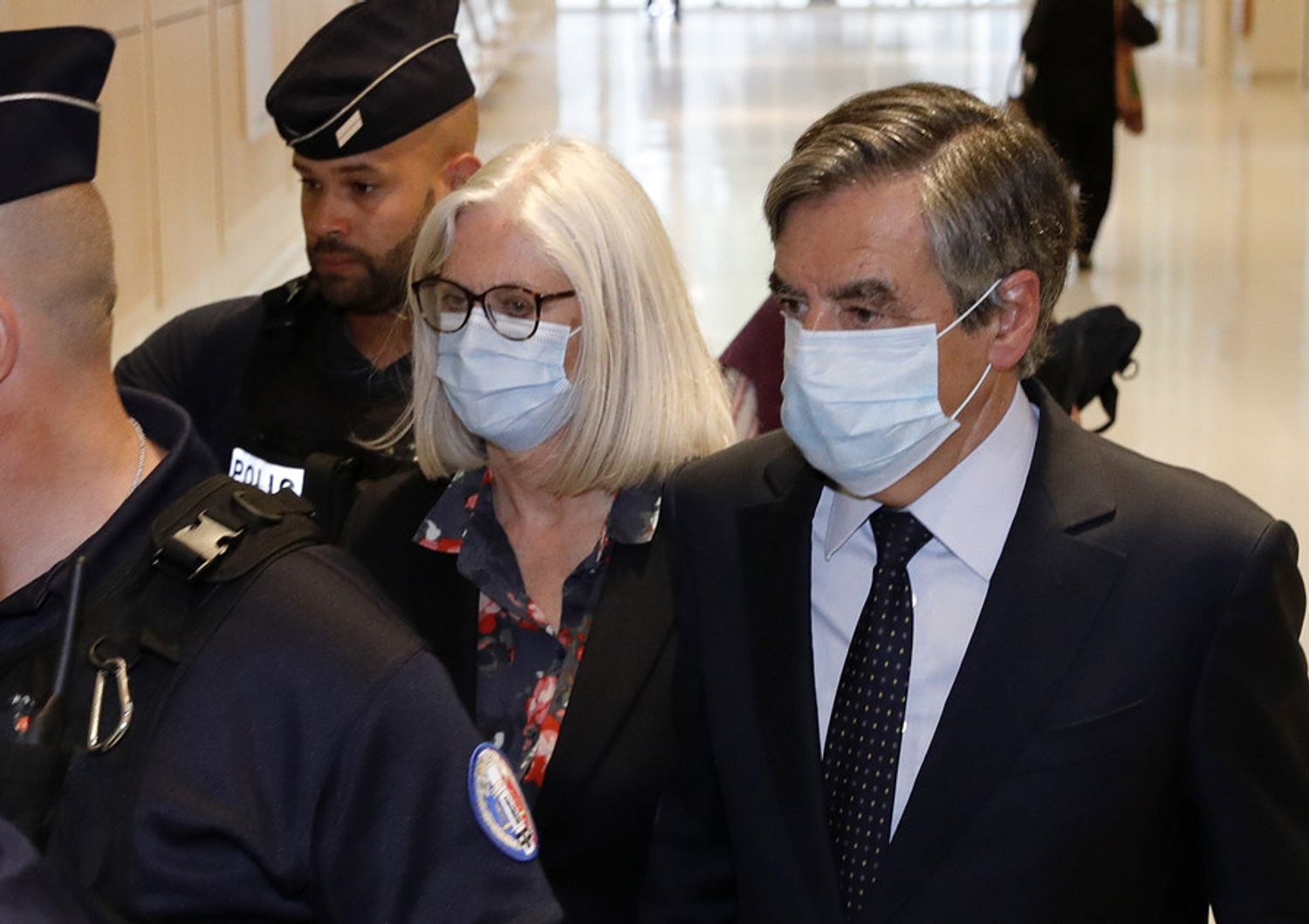 L'ex premier francese Francois Fillon e la moglie Penelope lasciano il tribunale dopo la condanna