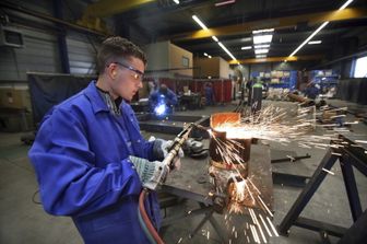 Industria: un saldatore al lavoro in un'azienda meccanica