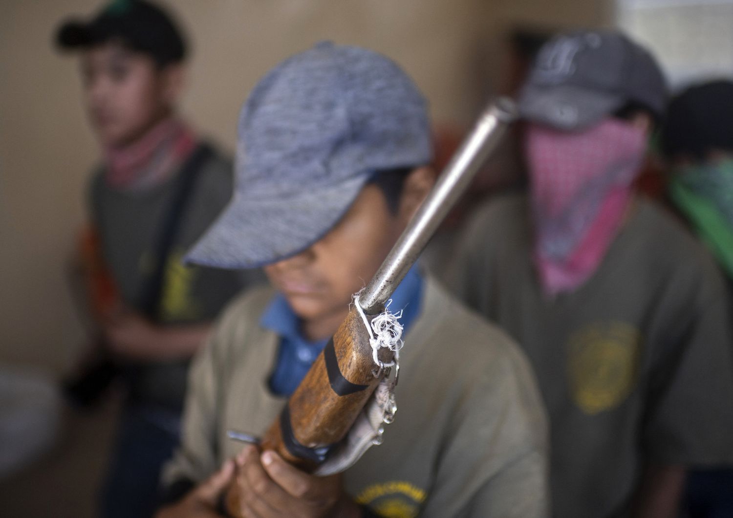 Un bambino con un fucile giocattolo si addestra alla guerriglia anti-narcos