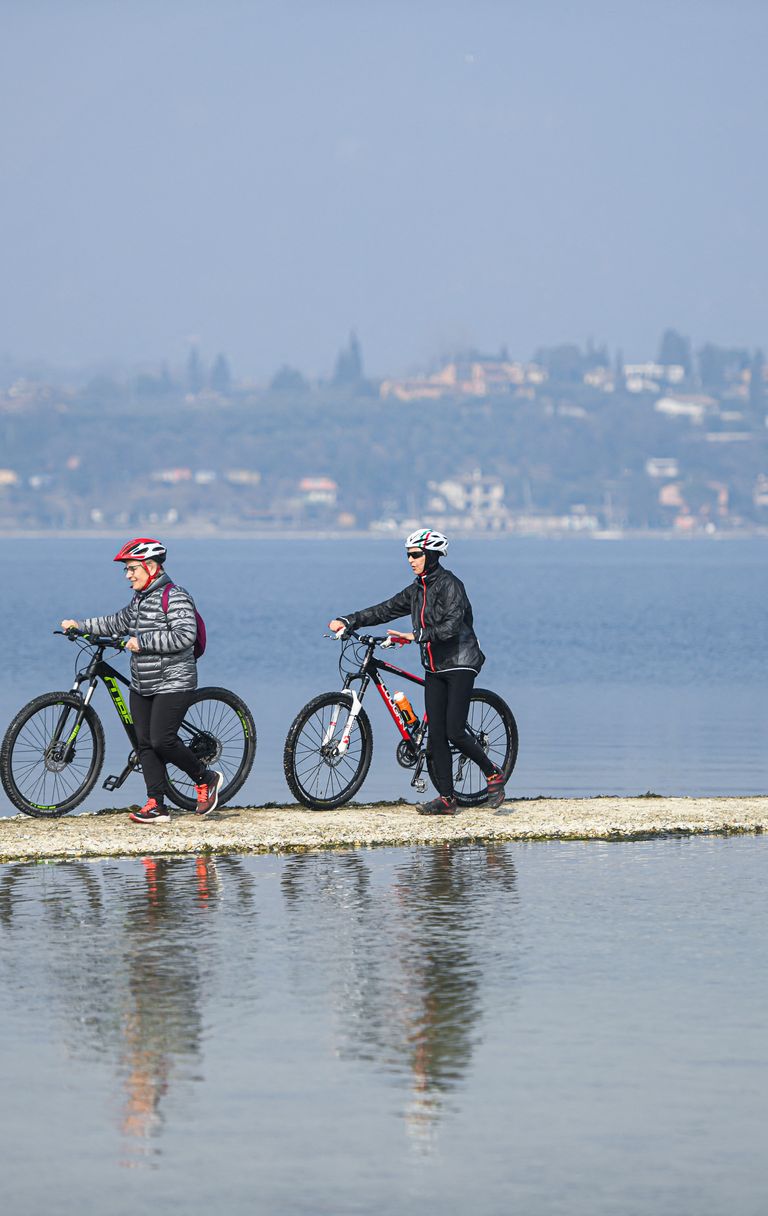 Turisti in bicicletta verso l'isola di San Biagio