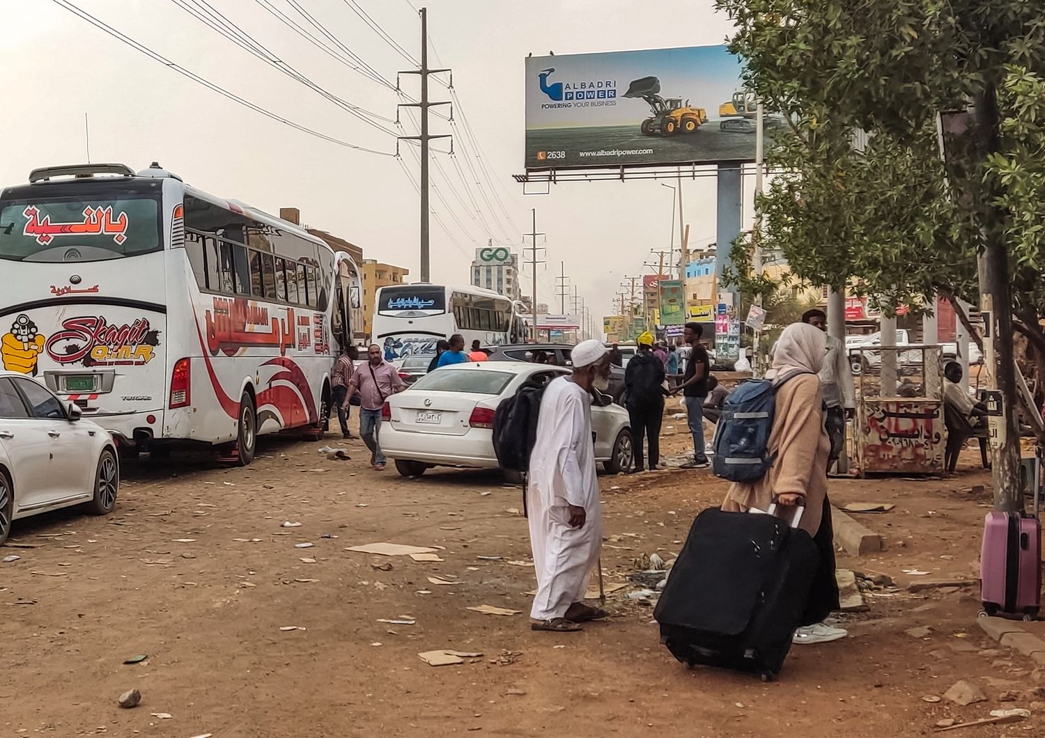 Civili in fuga dal Sudan cercano di salire su un pullman