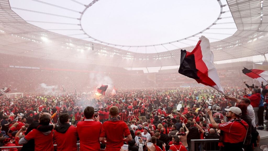 I tifosi del Leverkusen corrono in campo dopo la partita per festeggiare la vittoria del campionato tedesco