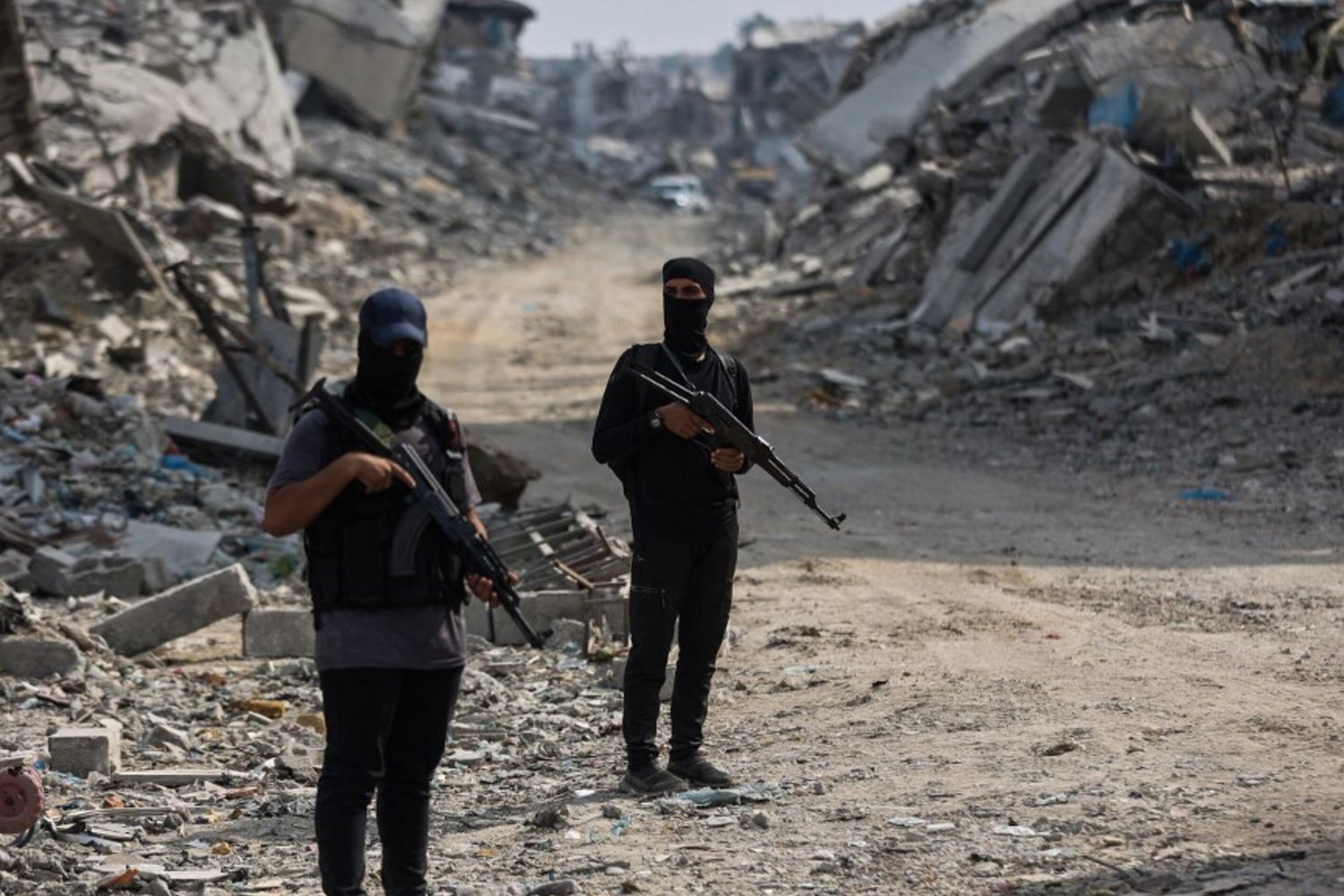 Militanti di Hamas sorvegliano un'area dove stanno cercando i corpi degli ostaggi