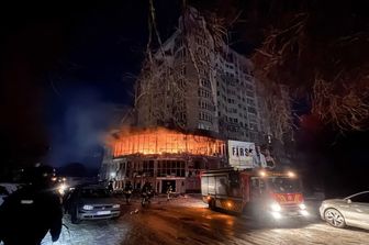 Vigili del fuoco vicino a un edificio residenziale in fiamme dopo un attacco di droni russi a Zaporizhia