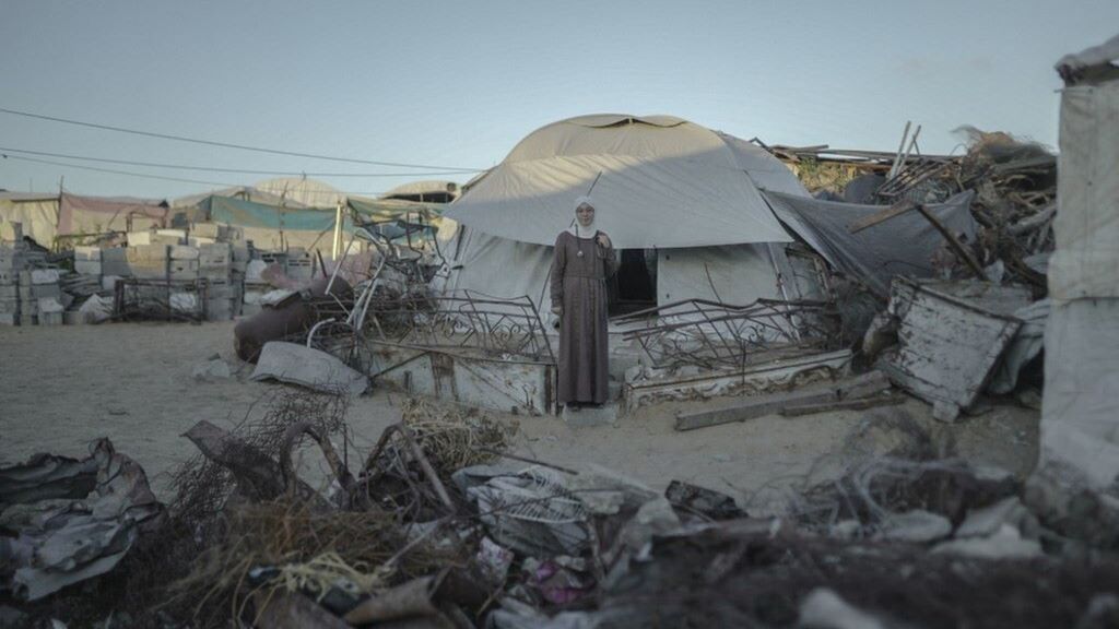 Una studentessa di medicina palestinese davanti a una tenda per sfollati circondata da macerie nella Striscia di Gaza  - immagine del 23 settembre 2026.